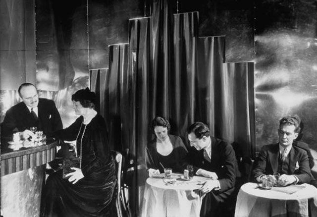 "Couples enjoying drinks at this unident. smart, modern speakeasy without police prohibition raids."